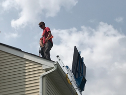 workers installing on roof